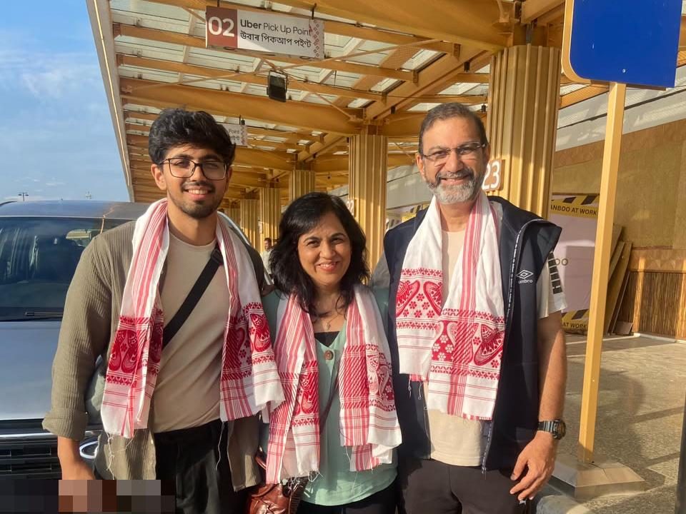 A family arriving in Guwahati with Happy Yatra Travels, gamosas and the Innova Crysta