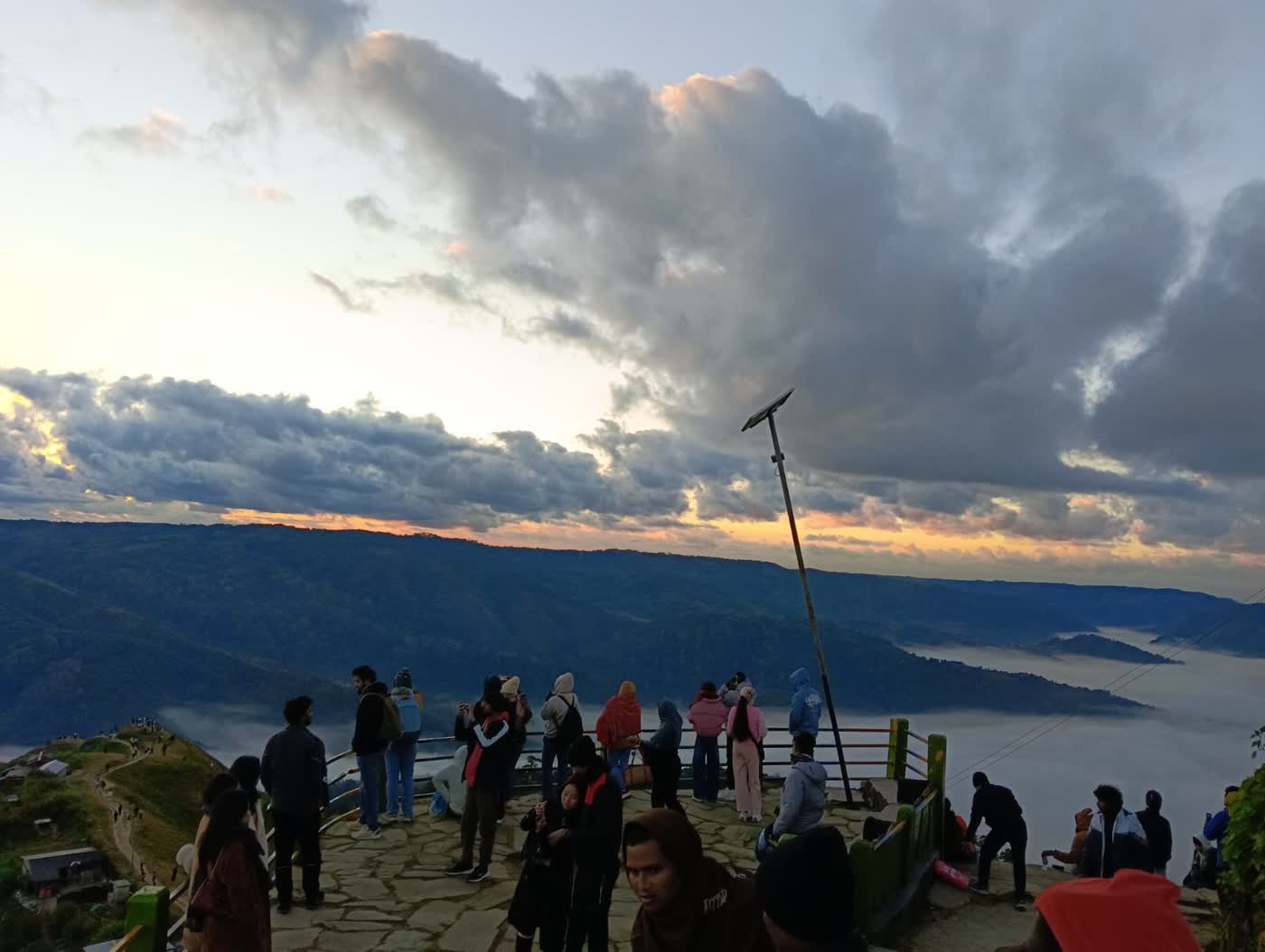Early-morning visitors gathered at a Meghalaya sunrise viewpoint